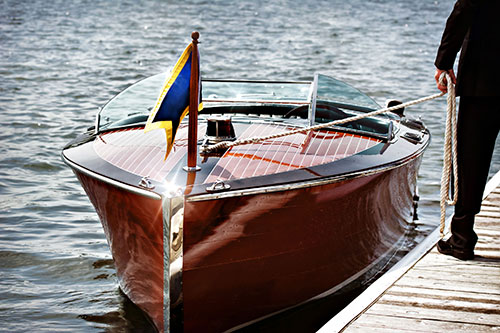 Boater inspecting and cleaning boat hull