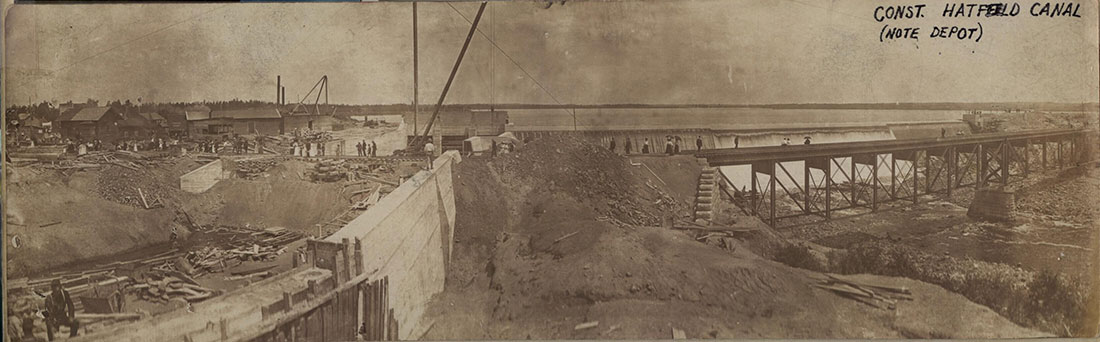 Historical photo of 1904 Hatfield dam construction and railroad bridge over Black River