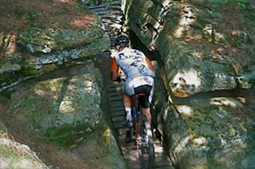 Mountain biker riding along sandstone bluffs at Levis Mound